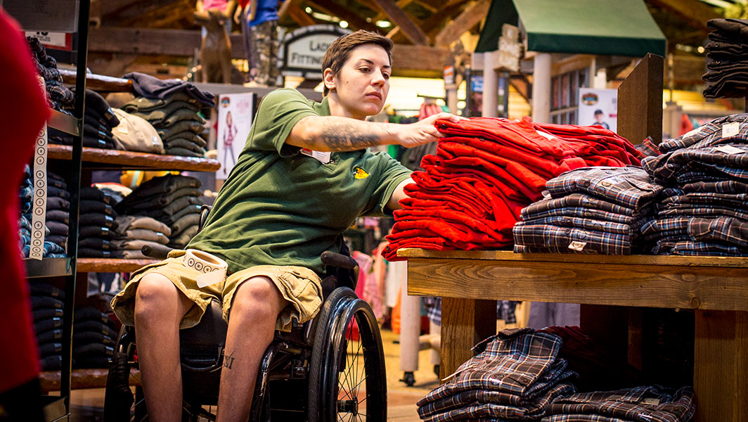 A person in a wheelchair working in a retail store.