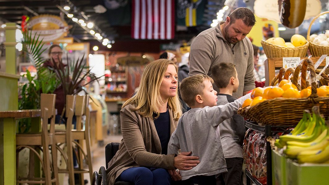 A family picking out produce in a market.