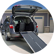 A wheelchair ramp hanging off the back of a SUV