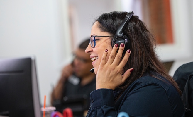 a smiling woman on the phone