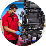 A NSM technician repairing a power chair.