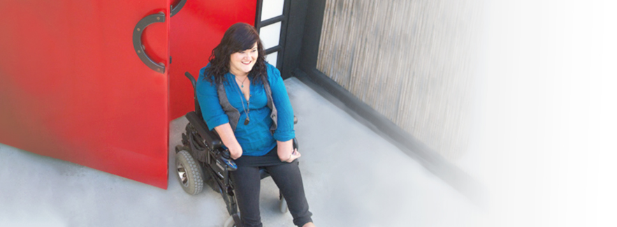 a woman going through a door in a wheelchair