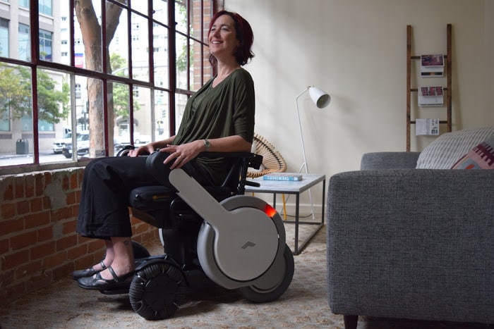 a woman in a wheelchair looking out the window