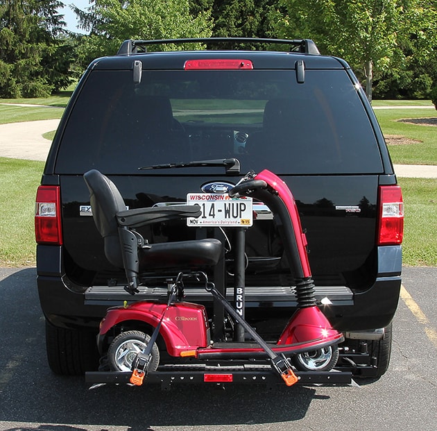 an exterior wheelchair lift holding a motorized scooter