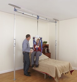 a woman getting out of bed using a lift