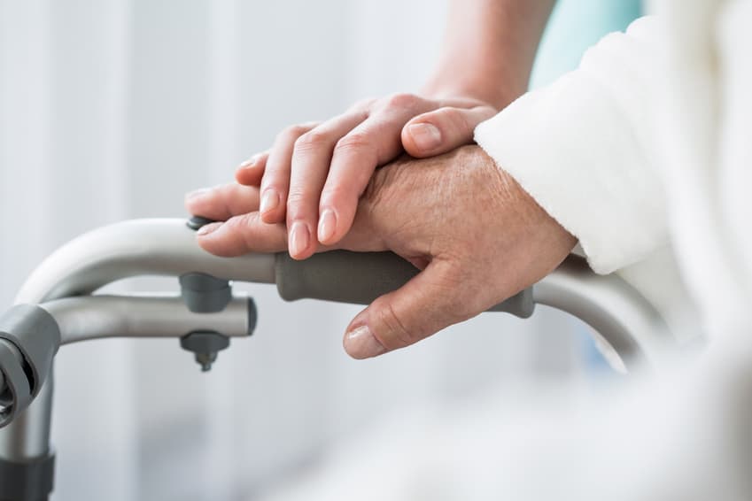 a hand over another comforting the individual