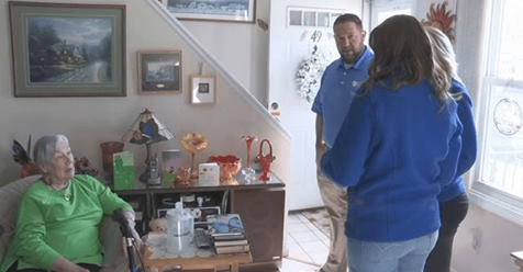 a woman greeting visitors at home