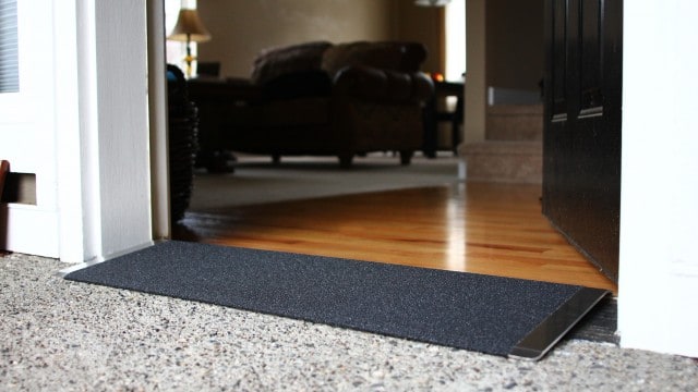 Black angled entry plate in front of a wood floor