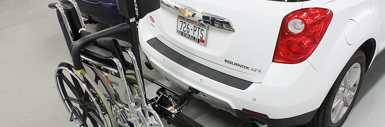 A side view of the Bruno Back Saver as it lifts a wheelchair into a car