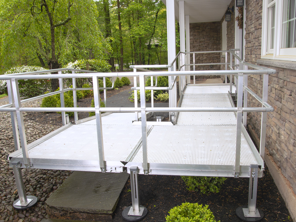 The side of an aluminum ramp in front of a house