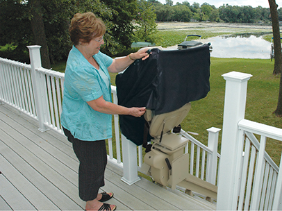 Woman putting cover on outdoor bruno stair lift