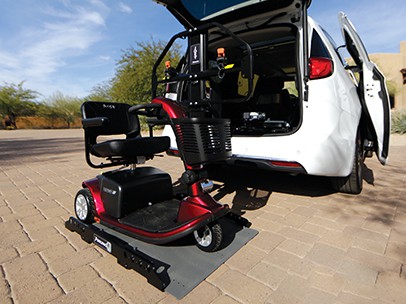 A wheelchair on a vehicle lift leading into a car