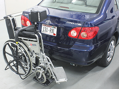 The Bruno Back Saver lifting a wheelchair into a car