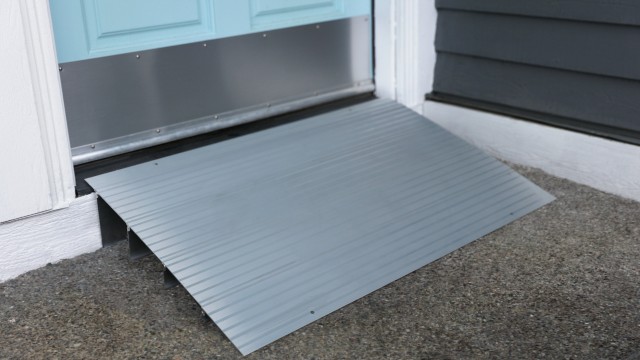 Modular entry ramp in front of a blue door