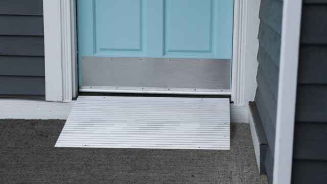 Modular entry ramp in front of a blue door
