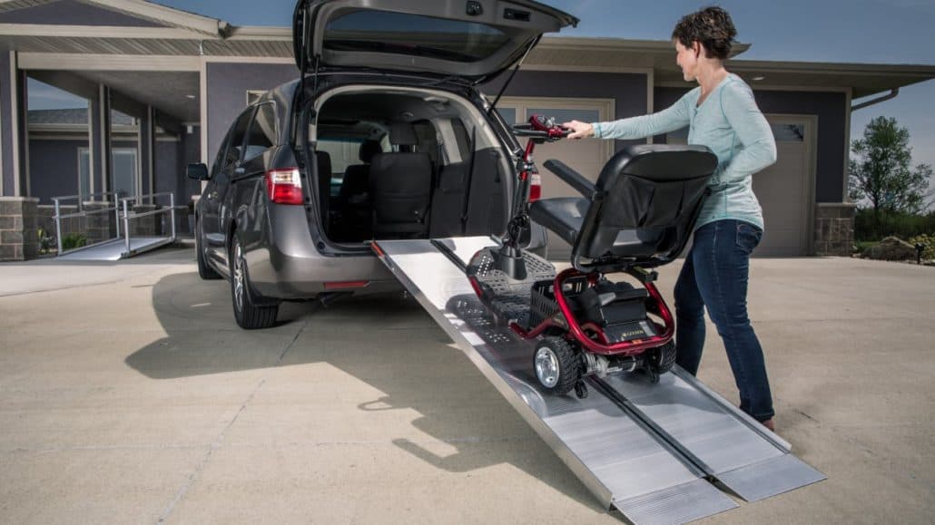 Singlefold ramp leading into a van with a wheelchair on it