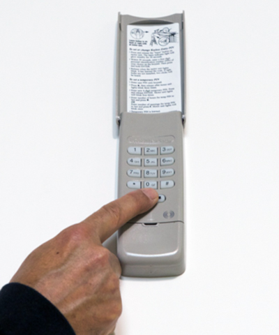 A hand using the Sesame Keypad