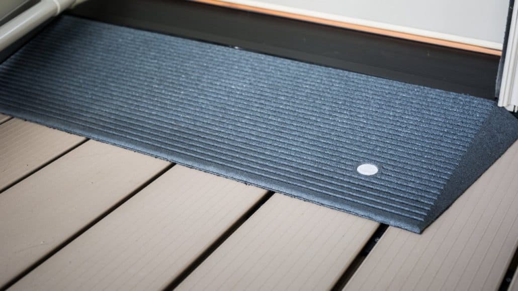 A blue angled entry mat in front of a door